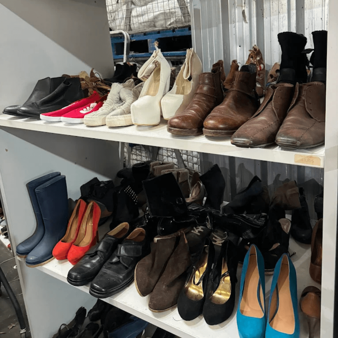 Shelves of secondhand shoes and boots