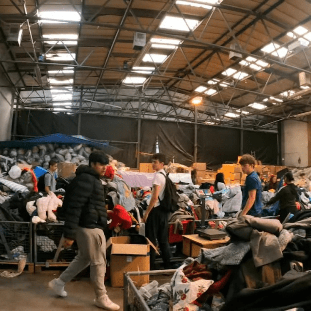 Sorting clothing by the kilo at the warehouse